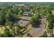 Aerial view of the community tennis courts with lush trees and surrounding landscaping at 26444 Sandpiper Ct, Fort Mill, SC 29707