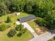 An aerial view of a ranch-style home with a long driveway, a shed, and a tree-lined yard at 279 Bailey Rd, Lancaster, SC 29720