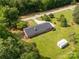 An aerial image of a single-Gathering home and shed with a well-kept lawn, driveway, and a tree-lined boundary at 279 Bailey Rd, Lancaster, SC 29720
