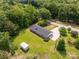 An aerial shot of a home with a large yard, long driveway, shed and a backdrop of towering mature trees at 279 Bailey Rd, Lancaster, SC 29720