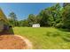 View of large backyard, outbuilding, and home at 279 Bailey Rd, Lancaster, SC 29720