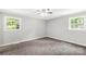 Bedroom with neutral walls, trim, carpet and ample natural light from two windows at 279 Bailey Rd, Lancaster, SC 29720