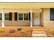 Inviting front porch featuring brick steps, white columns, and black shutters at 279 Bailey Rd, Lancaster, SC 29720