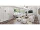 Bright living room featuring hardwood floors, white furniture, and natural light from large windows at 279 Bailey Rd, Lancaster, SC 29720