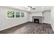 Cozy living room with a brick fireplace, built-in shelving, and large windows offering ample natural light at 279 Bailey Rd, Lancaster, SC 29720