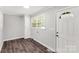 Practical mud room featuring wood-look flooring, a window, and a white door at 279 Bailey Rd, Lancaster, SC 29720