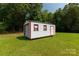 Shed featuring white siding with red trim and a door at 279 Bailey Rd, Lancaster, SC 29720