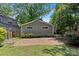Charming backyard with brick patio and lush greenery for relaxation and entertainment at 2813 Hilliard Dr, Charlotte, NC 28205