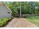 Brick patio with manicured backyard featuring mature trees and lawn at 2813 Hilliard Dr, Charlotte, NC 28205