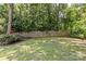 Private backyard featuring a manicured lawn and lush greenery at 2813 Hilliard Dr, Charlotte, NC 28205
