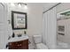 This bathroom features a wood vanity, framed mirror, neutral paint, and a tub with a shower curtain at 2813 Hilliard Dr, Charlotte, NC 28205