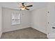 A bedroom featuring a ceiling fan, carpeted floor, baseboard trim, and a window with blinds at 2813 Hilliard Dr, Charlotte, NC 28205