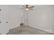 This is a bedroom with a ceiling fan, a door, neutral paint, and carpeted floor at 2813 Hilliard Dr, Charlotte, NC 28205