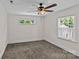 This is a bedroom with a ceiling fan, a window, neutral paint, and carpeted floor at 2813 Hilliard Dr, Charlotte, NC 28205