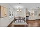 Cozy dining area with a wooden table, chandelier, and natural light, adjacent to the kitchen at 2813 Hilliard Dr, Charlotte, NC 28205