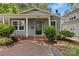 Charming gray home featuring manicured landscaping, a brick walkway and welcoming front porch at 2813 Hilliard Dr, Charlotte, NC 28205