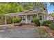 Inviting gray home featuring a covered parking area, brick walkway, and front yard shrubbery at 2813 Hilliard Dr, Charlotte, NC 28205