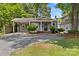 Quaint gray home with covered parking, complemented by brick walkway and lush green yard at 2813 Hilliard Dr, Charlotte, NC 28205