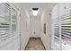 Bright hallway featuring tile floors and natural light from windows at both ends at 2813 Hilliard Dr, Charlotte, NC 28205