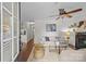 Bright living room featuring fresh white paint, fire place, ceiling fan, and wood flooring at 2813 Hilliard Dr, Charlotte, NC 28205