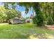 Lush backyard showing green grass, mature trees, and multiple residences at 2819 Georgia Ave, Charlotte, NC 28205
