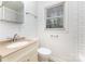 Well-lit bathroom featuring classic fixtures, white tiles, and a bright window at 2819 Georgia Ave, Charlotte, NC 28205