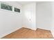 Well-lit bedroom featuring hardwood floors and a classic white door at 2819 Georgia Ave, Charlotte, NC 28205