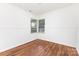 Bedroom featuring wood floors, white walls, and a window at 2819 Georgia Ave, Charlotte, NC 28205