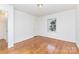 Bedroom with wood floors, white paneled walls and natural light at 2819 Georgia Ave, Charlotte, NC 28205