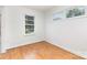 Bright bedroom featuring hardwood floors, white walls, and two windows at 2819 Georgia Ave, Charlotte, NC 28205