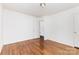 Bedroom featuring hardwood floors, white walls, and two doors at 2819 Georgia Ave, Charlotte, NC 28205
