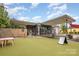 Exterior of a unique building with a flat roof, artificial turf, and outdoor seating area at 2819 Georgia Ave, Charlotte, NC 28205