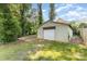 Detached garage in a lush backyard, offering ample storage and parking space at 2819 Georgia Ave, Charlotte, NC 28205