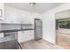 Functional kitchen featuring stainless steel appliances, white cabinets, and updated countertops at 2819 Georgia Ave, Charlotte, NC 28205