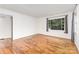 Bright living room featuring hardwood floors, fresh paint, and a large window with backyard views at 2819 Georgia Ave, Charlotte, NC 28205