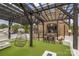 Charming outdoor patio with a pergola, comfortable seating, string lights, and a welcoming entrance to the building at 2819 Georgia Ave, Charlotte, NC 28205