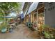 Outdoor seating area with tables and chairs is surrounded by greenery, creating a cozy spot for enjoying a meal or coffee at 2819 Georgia Ave, Charlotte, NC 28205