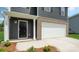 Inviting front entrance with a covered porch and a direct access to the attached two-car garage at 3025 Ora Smith Rd, Lincolnton, NC 28092