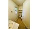Functional bathroom with tile floor, built-in storage, and window at 316 Meadowood Cir, Kannapolis, NC 28081