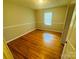 Cozy bedroom with neutral walls, hardwood floors, closet, and window allowing natural light at 316 Meadowood Cir, Kannapolis, NC 28081