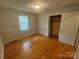 Bedroom with window, hardwood flooring, neutral walls, and closet at 316 Meadowood Cir, Kannapolis, NC 28081