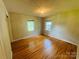Bright bedroom with hardwood floors, chandelier, and two windows at 316 Meadowood Cir, Kannapolis, NC 28081