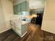 Well-lit kitchen with green cabinets and stainless steel appliances at 316 Meadowood Cir, Kannapolis, NC 28081