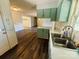 Cozy kitchen with green cabinetry and a stainless steel sink at 316 Meadowood Cir, Kannapolis, NC 28081