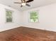 Spacious, well-lit bedroom with two windows, hardwood floors, and a ceiling fan for added comfort at 3339 Benard Ave, Charlotte, NC 28206