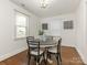 Bright dining room featuring a round table with seating for four, accented by stylish wall decor and hardwood floors at 3339 Benard Ave, Charlotte, NC 28206
