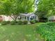 Charming home featuring lush landscaping, healthy green grass, manicured bushes, and a cozy, inviting facade at 3339 Benard Ave, Charlotte, NC 28206