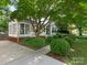 Landscaped front yard with rounded bushes leading to a charming home exterior and blue door at 3339 Benard Ave, Charlotte, NC 28206