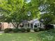Charming one-story home with lush landscaping, mature trees, and a welcoming front yard at 3339 Benard Ave, Charlotte, NC 28206