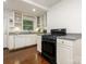 Well-lit kitchen with white cabinetry, dark hardware, and modern appliances at 3339 Benard Ave, Charlotte, NC 28206